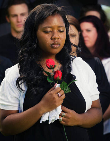 Well-dressed woman holding a rose with tears on her face, symbolizing the emotional importance of final expense insurance in Georgia through Crook & Covenant.